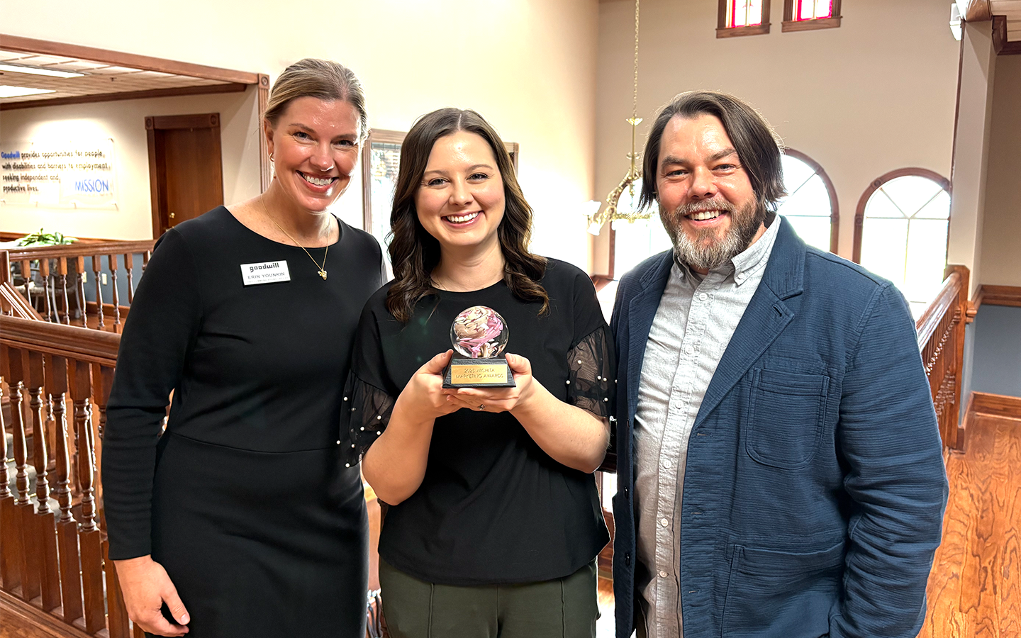 Marketing personnel holding the 2025 AMA Integrated Marketing Campaign award.